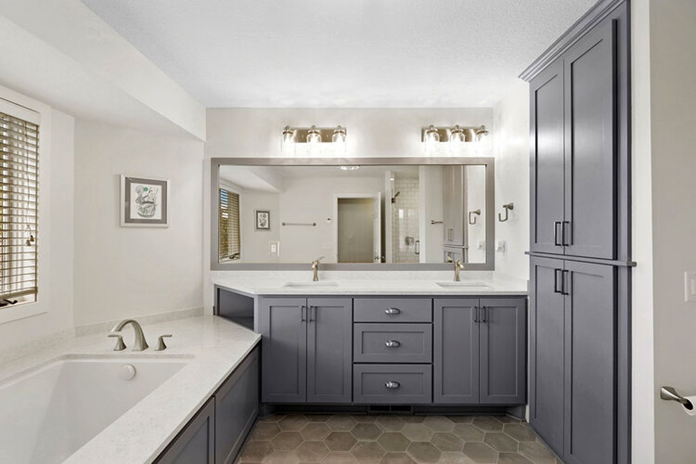 Double-sink vanity, tub surround, linen cupboard