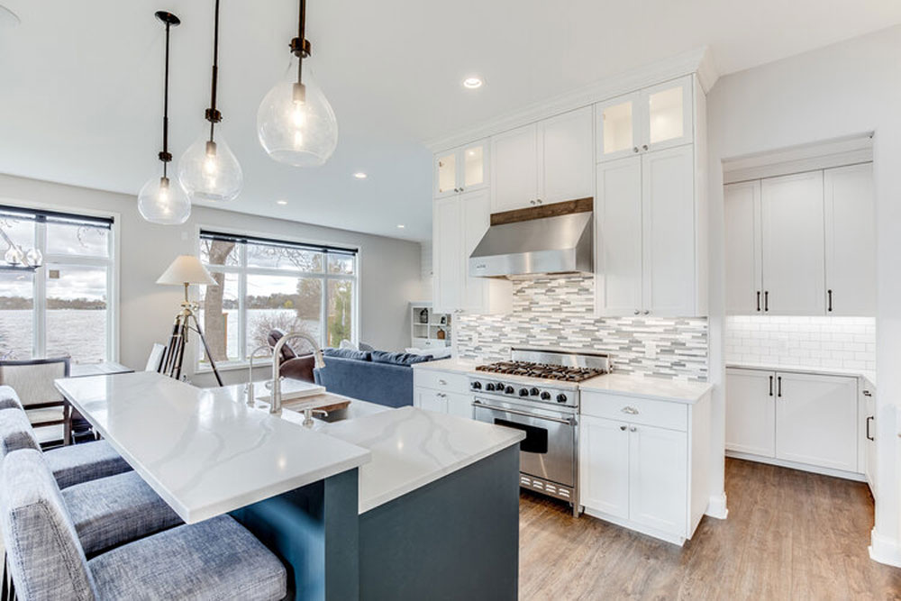 White cabinets/contrasting blue island w/seating